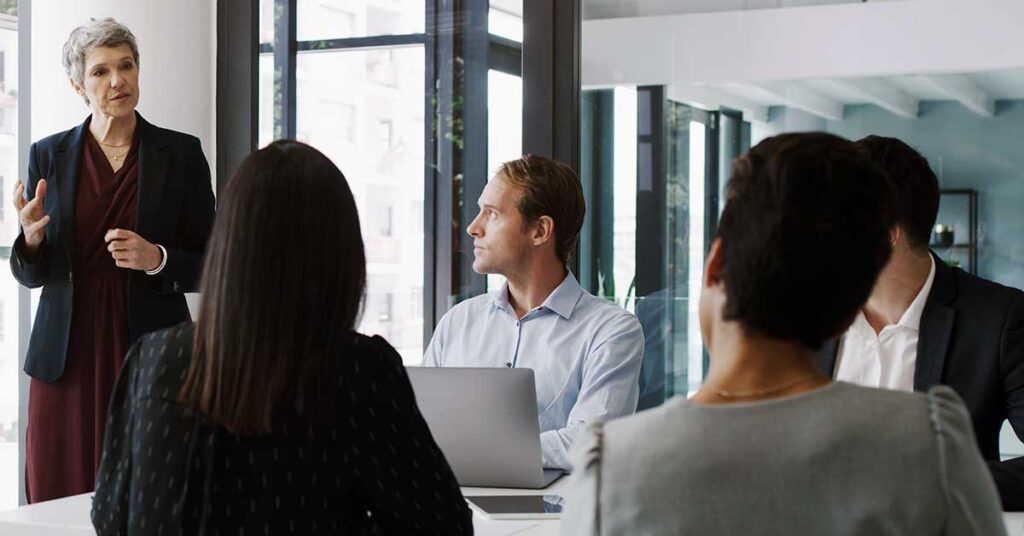 mature businessman delivering a presentation during a boardroom meeting