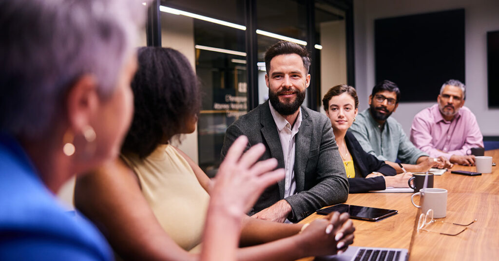 Stakeholder meeting around a table in board room