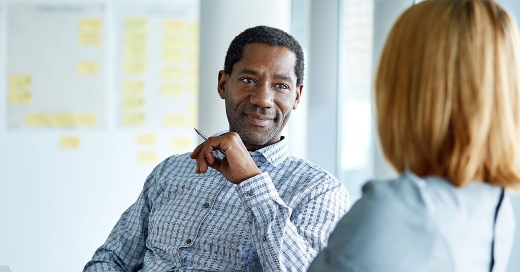 male and female colleagues discussing work