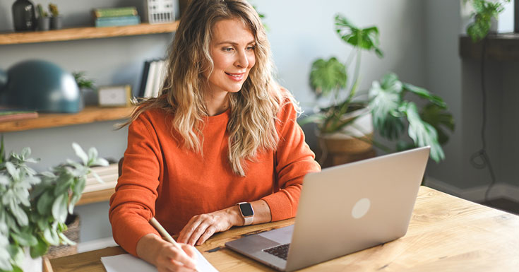 mature adult woman working at home