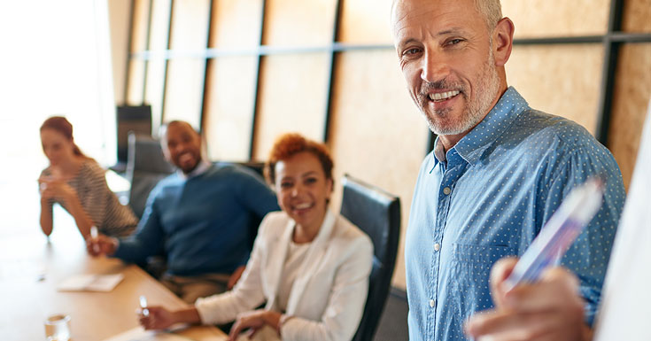 mature businessman delivering a presentation in a boardroom