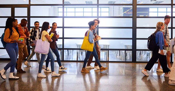 College students walking down a hallway