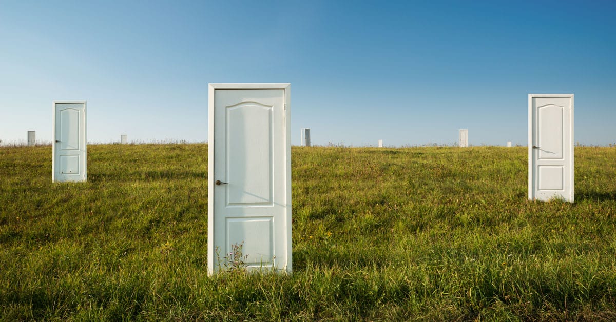 many white doors in a green field